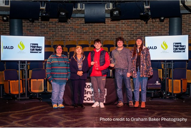 Group of people being presented with their awards