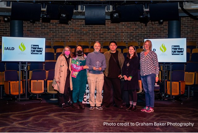 Group of people being presented with an award